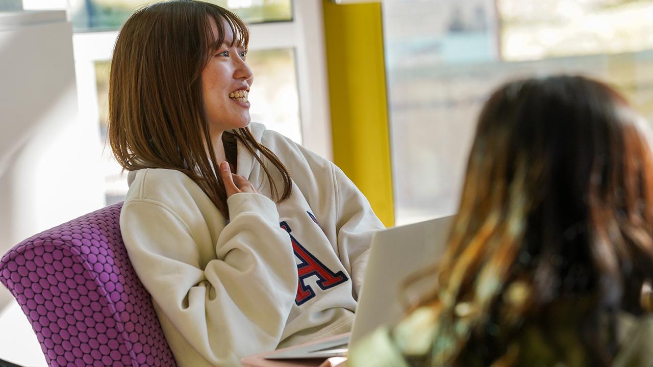 A student sits and talks in the UC Davis International Center