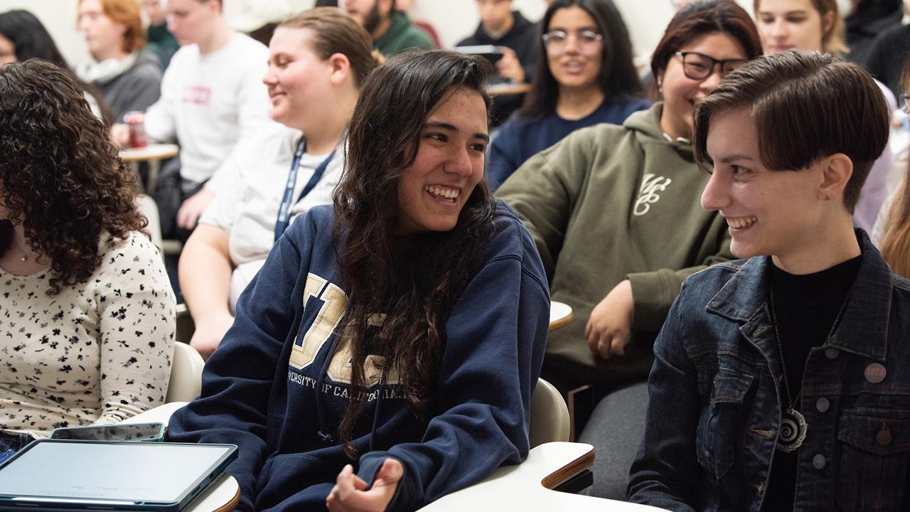 Students share a laugh before the start of the lecture.