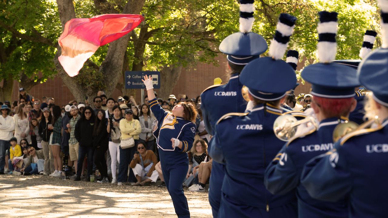 UC Davis Marching Band and flag bearer perform during Picnic Day