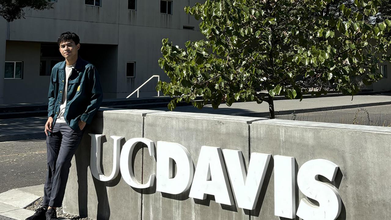 Global Study Program student Muhammad Faiz Satrio poses in front of the UC Davis sign
