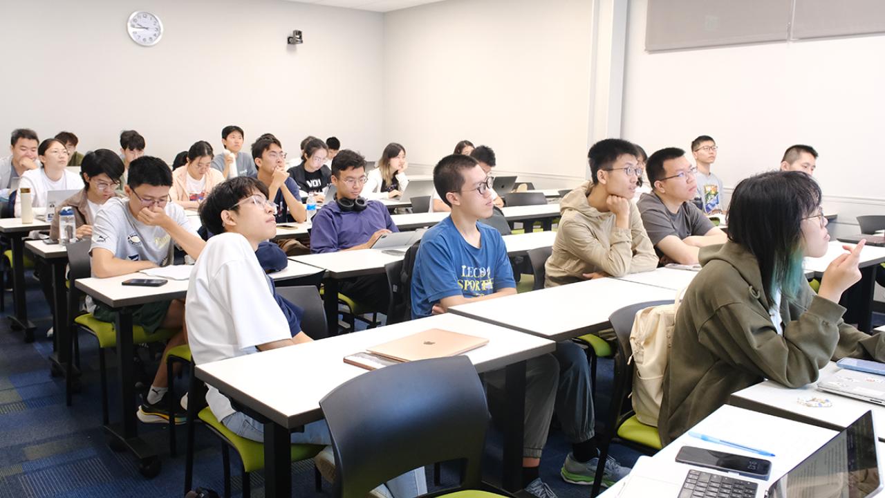 students fill a classroom at the UC Davis International Center as they sit and listen to a presentation