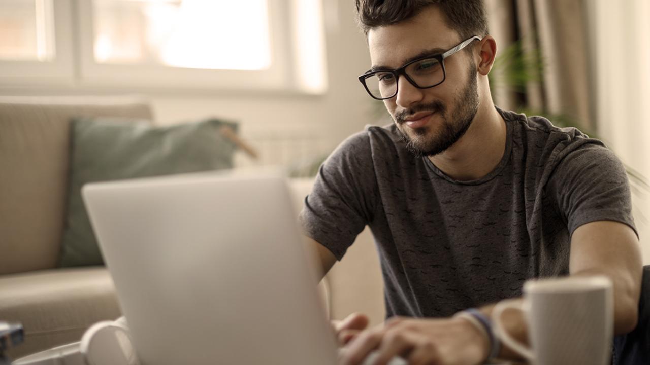 a young man at home on laptop