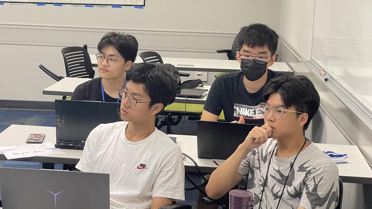 students in an international youth program sit in class listening to a presentation