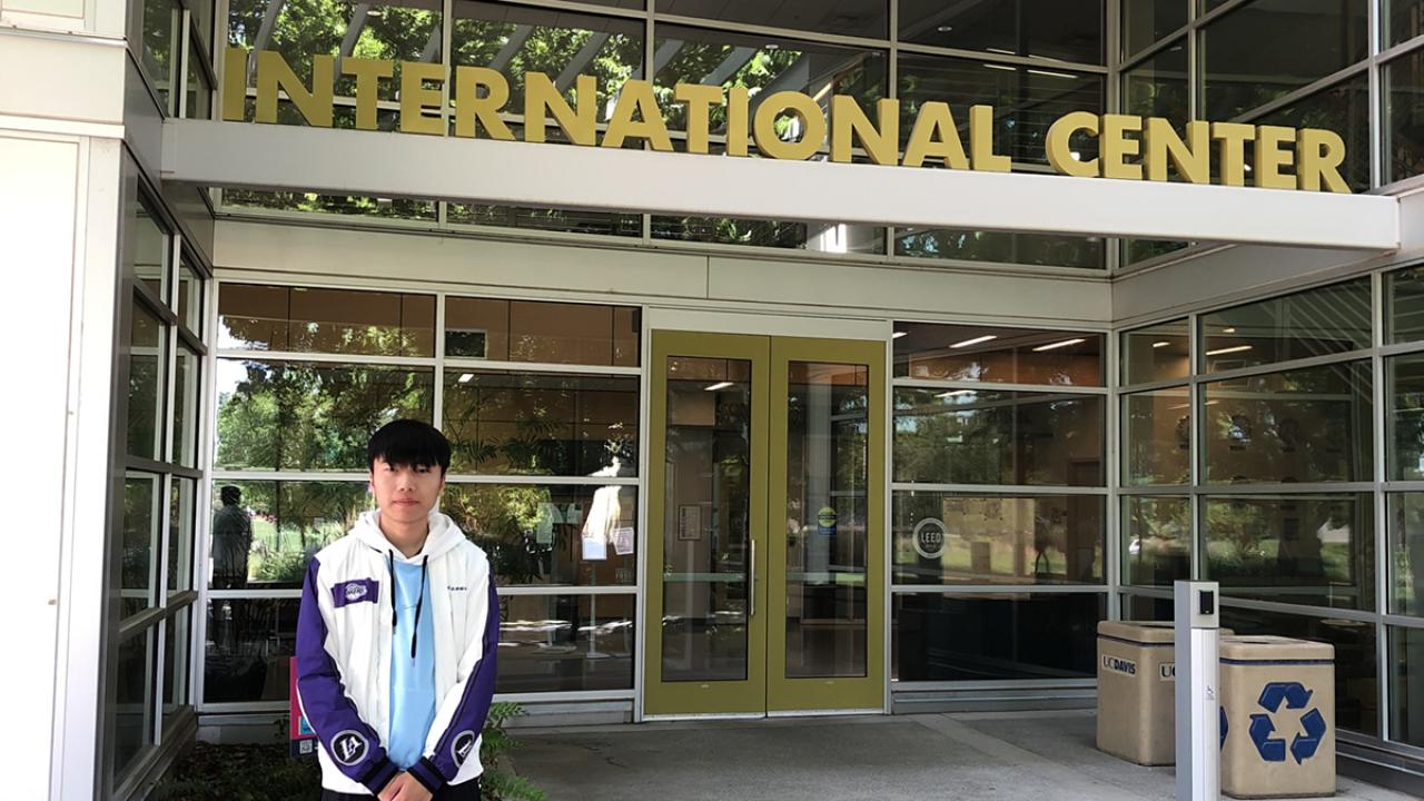 UC Davis Community College Pathway student Eddie Lu poses in front of the International Center