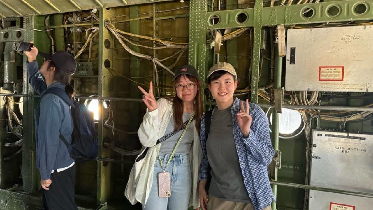 UC Davis international students pose in an airplane at the Aerospace Museum of California