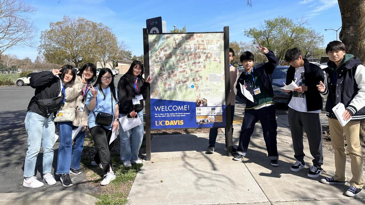 Seikei High School students pose next to map of UC Davis