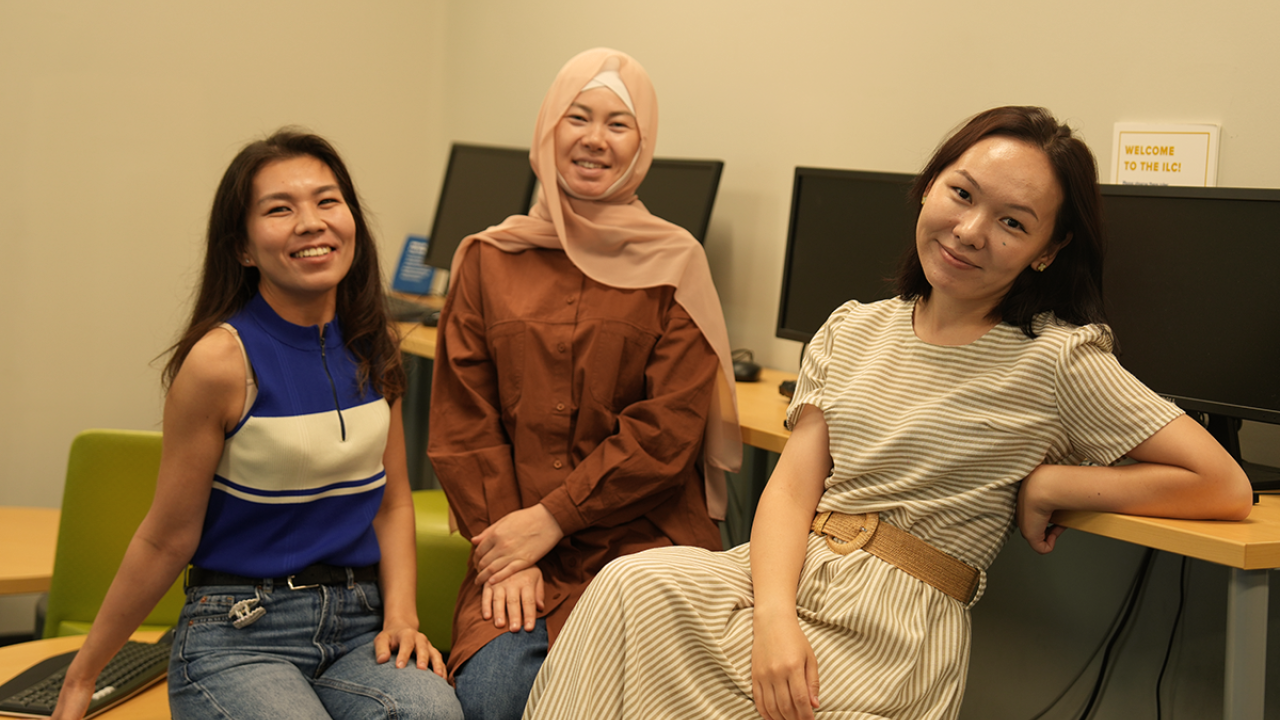 three Kazakh scholars pose for a photo during orientation at UC Davis