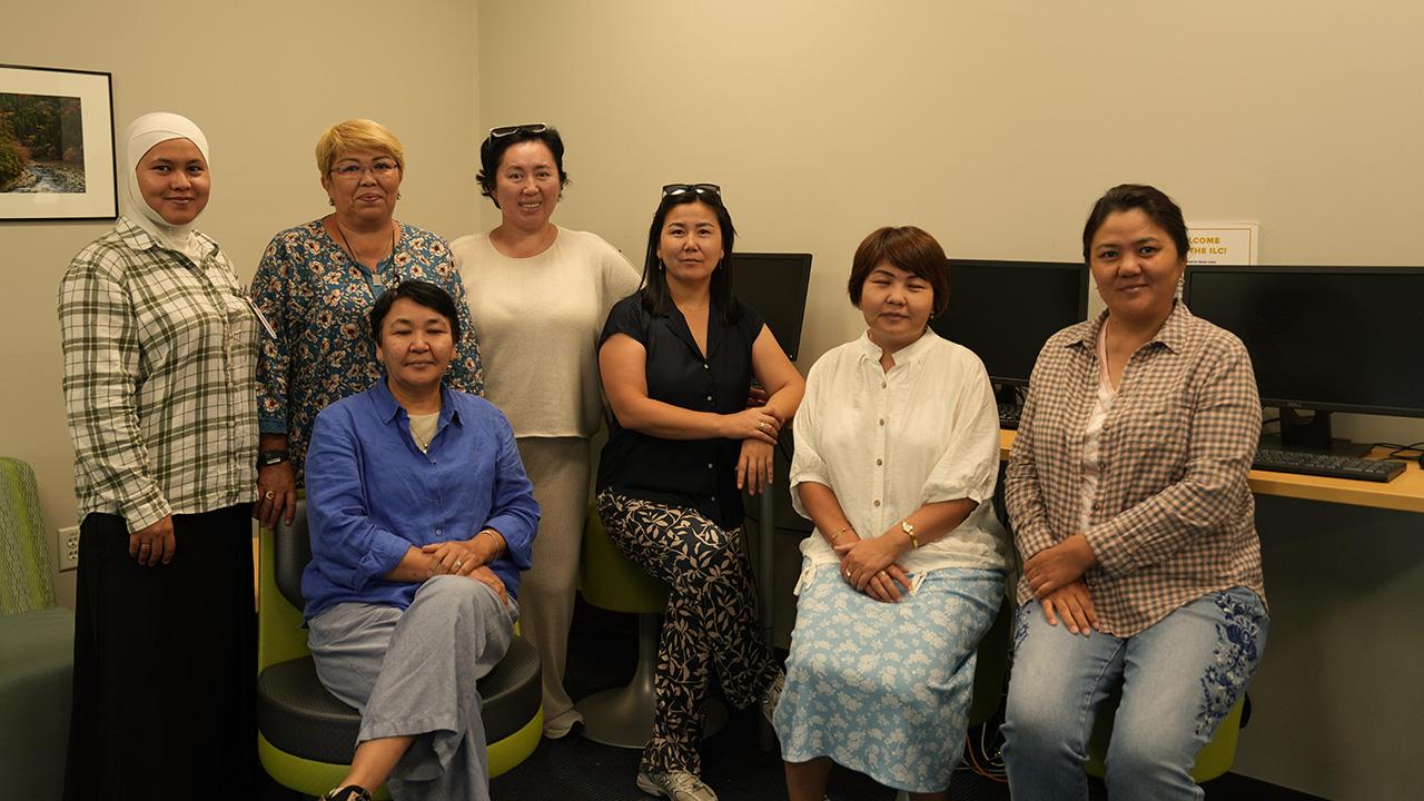 a group of Kazakh scholars pose for a photo at the UC Davis International Center