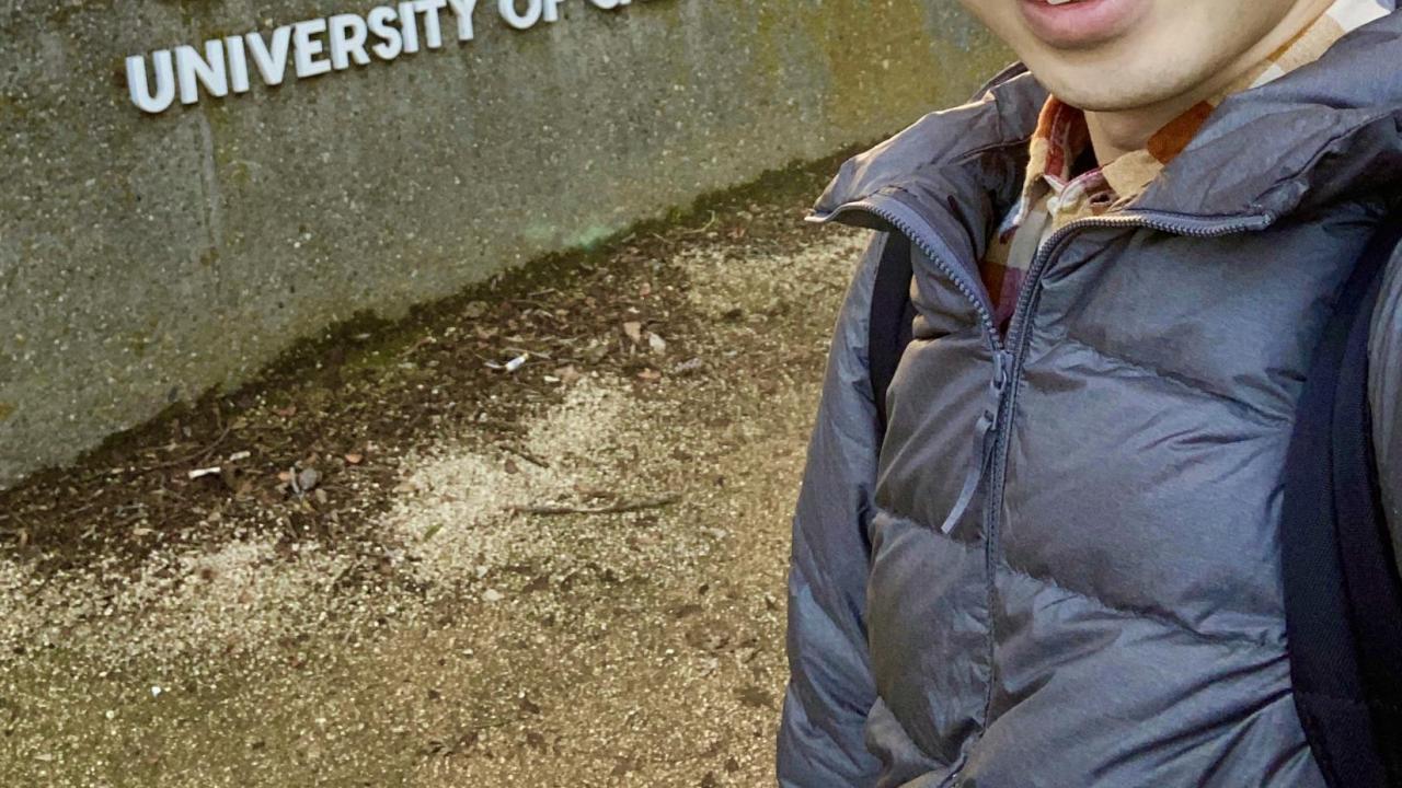 Ryotaro Okada next to the UC Davis sign