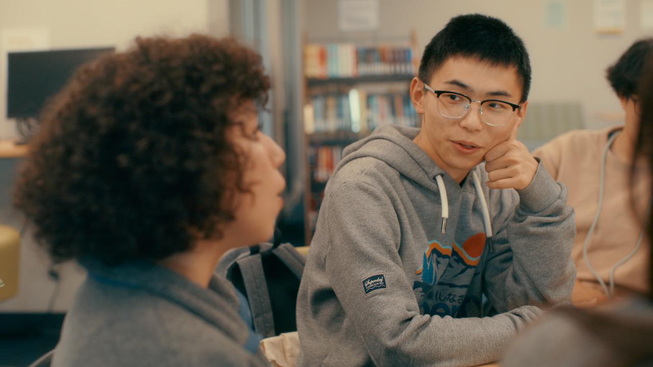 UC Davis international students it in a classroom talking to each other