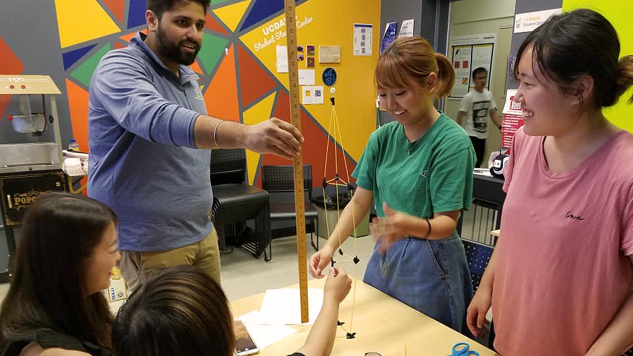 an instructor works with students on a hands-on project at the UC Davis Startup Center