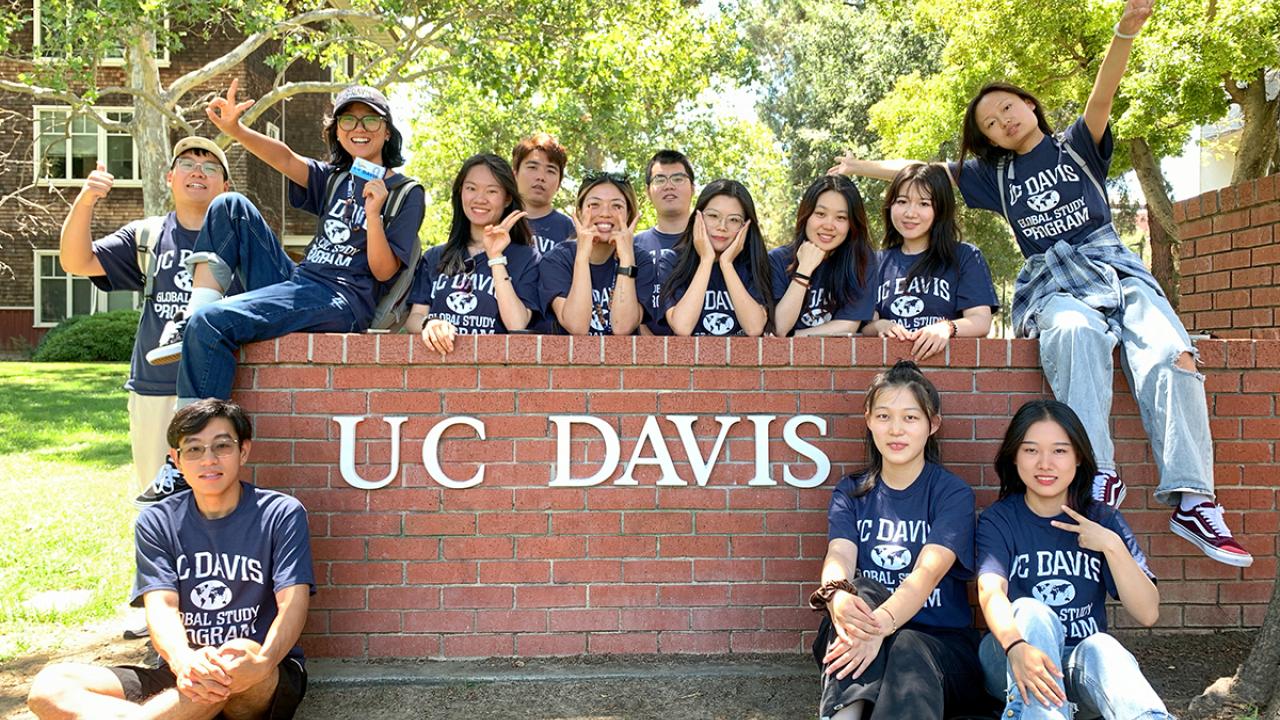 students from Shandong Ag University pose in front of the UC Davis sign for a group photo