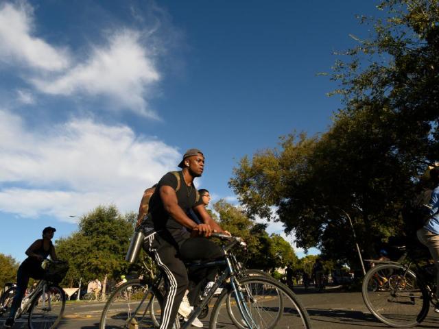 On the first day of classes, students ride their bikes through the bike circle on Hutchison Drive