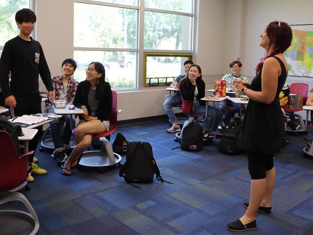 an instructor talks with a student during class in the International Center