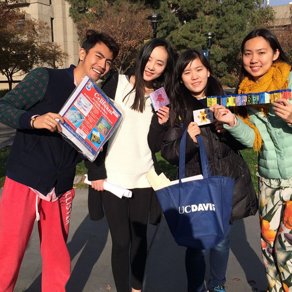 international youth students pose with their projects