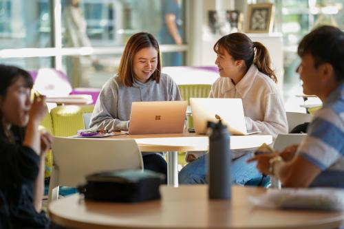 students chat in the International Center while studying