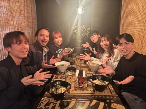 UC Davis International Programs student poses with friends at a restaurant for dinner