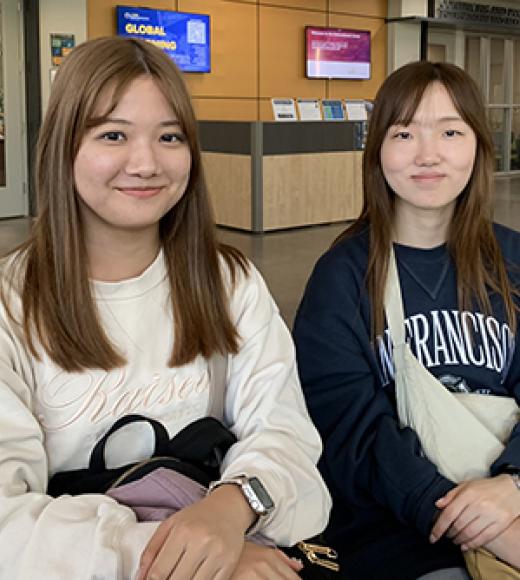 Students Yuka Fukushima and Haruka Ojida pose for a photo at the International Center