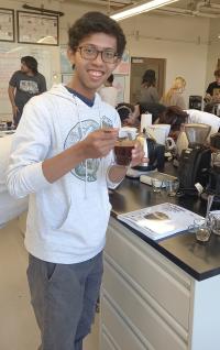 Student Bimo Abdusshamad cups coffee in the UC Davis Coffee Lab