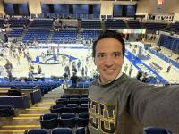 International business student at UC Davis Carlos Maya Ortega takes a selfie at a UC Davis basketball game