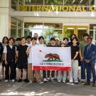 Students from Korea University hold up the flag of California
