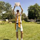 Global Study Program graduate Felix Speicher holds up his certificate of completion from UC Davis