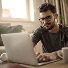 a young man at home on laptop