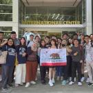 group of Indonesian students with California flag outside International Center