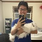 UC Davis GREAT research student takes a selfie with a cat at his homestay
