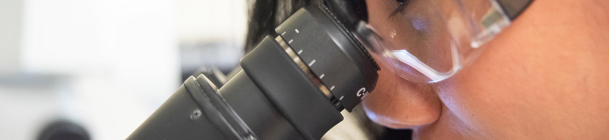 girl looking in microscope