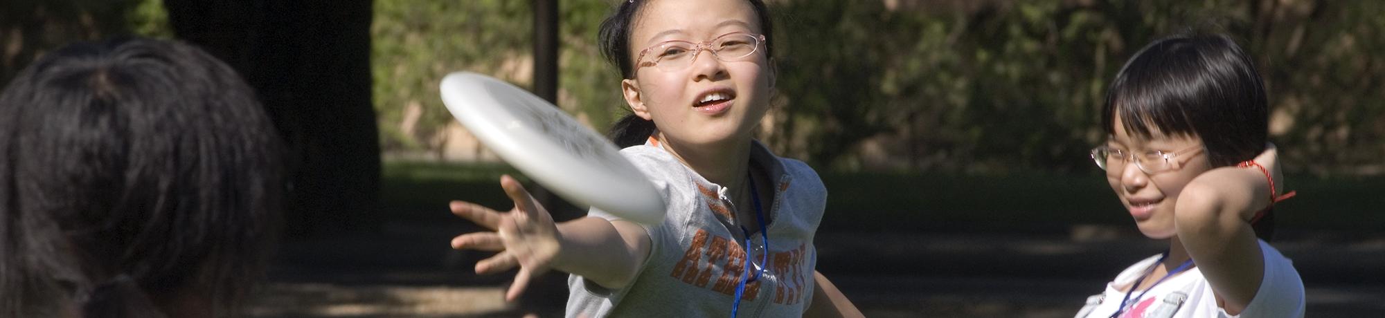 students playing frisbee