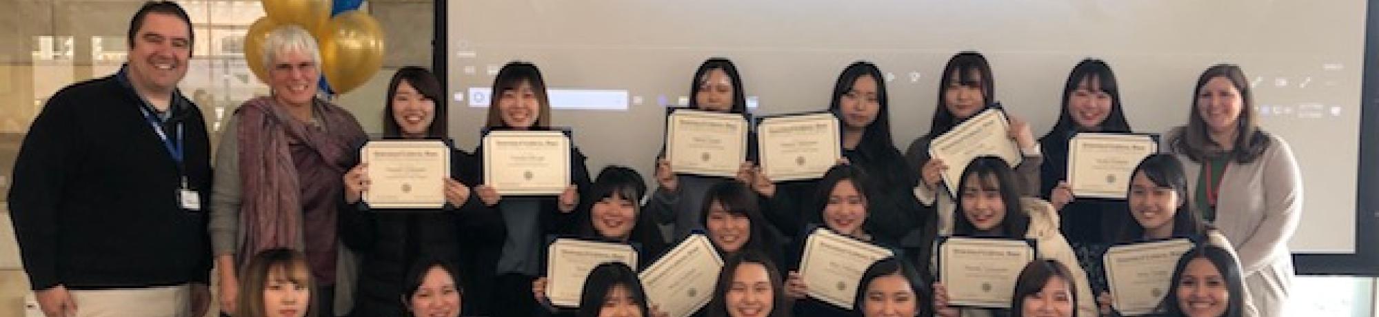 Group photo of students holding their certificates