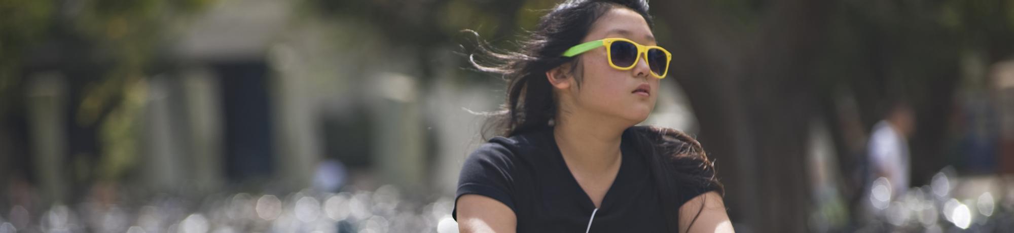 student on bike at UC Davis campus