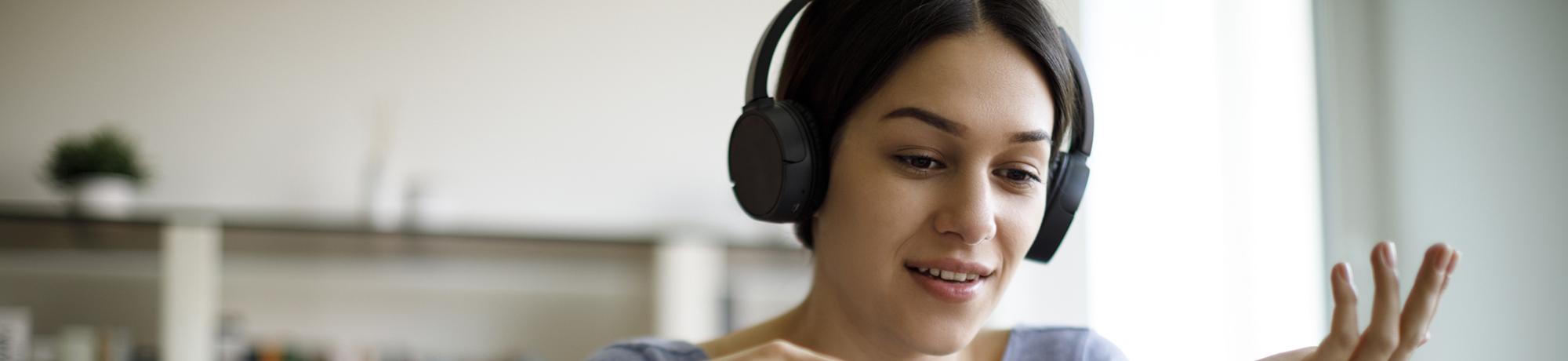 student at computer with headphones