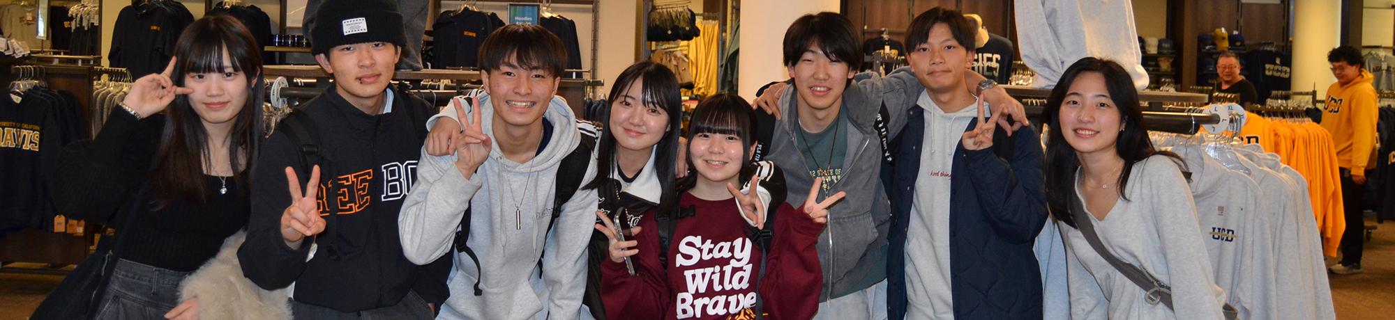 international youth students pose for a group photo at the UC Davis store