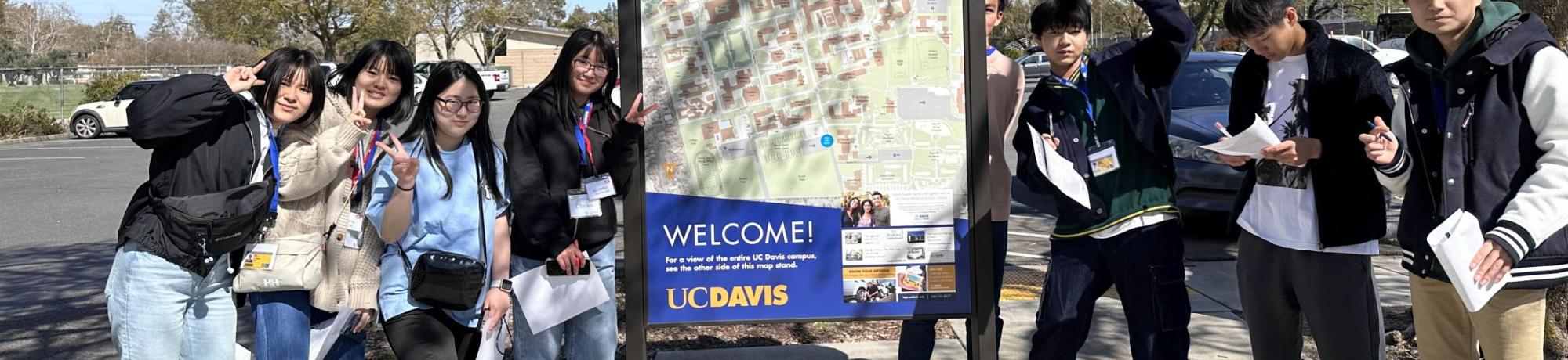 Seikei High School students pose next to map of UC Davis