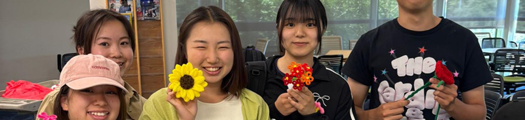 UC Davis international students pose with flowers they made for Mother's Day